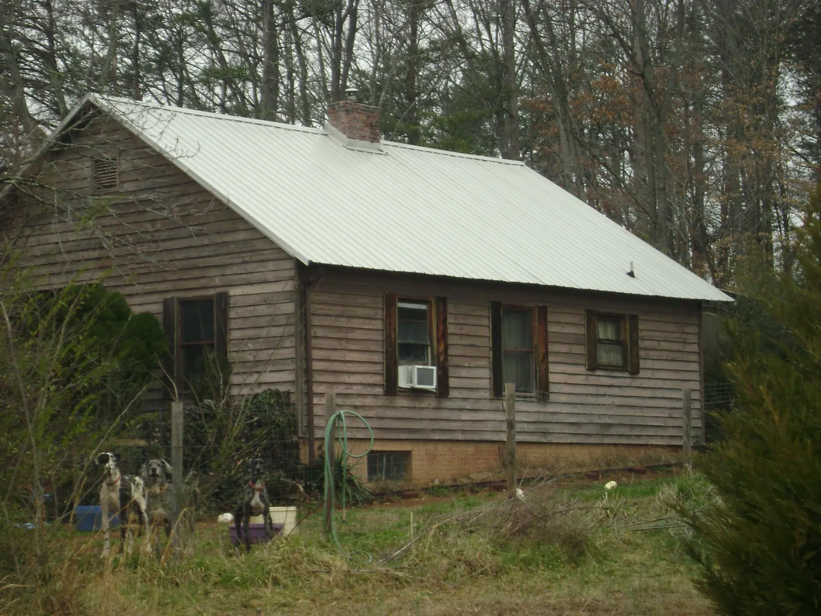 White metal roof on an old wood sided farmhouse, from a Metal Roof Installation job in Blockton
